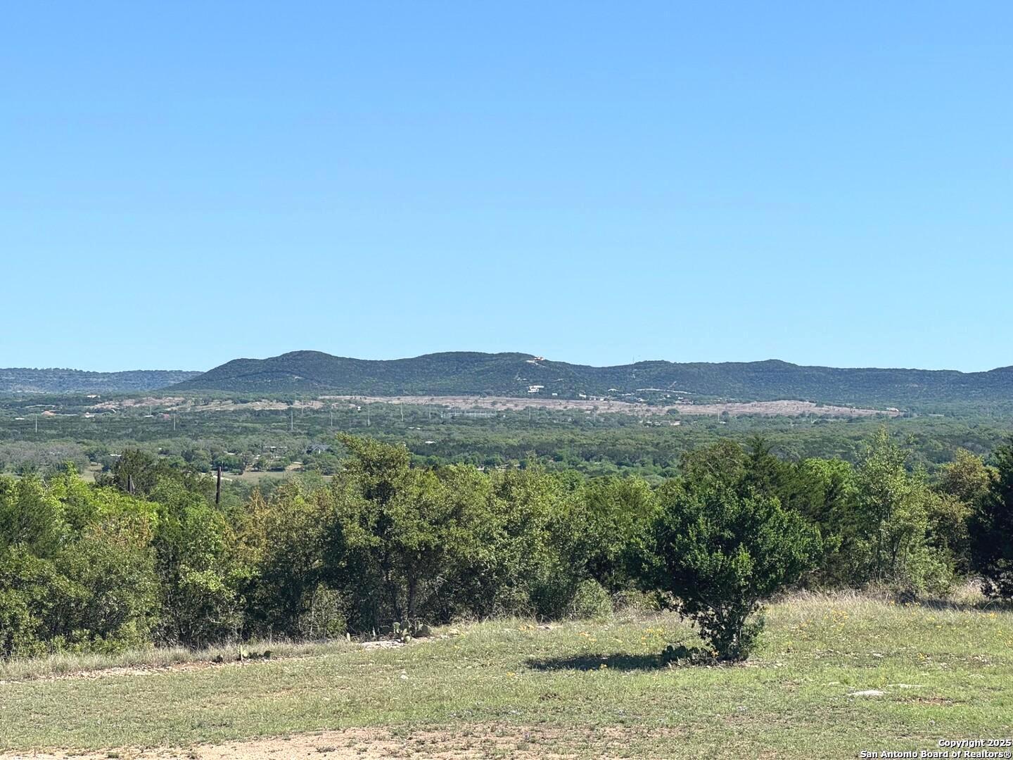 2485 Bump Gate Road Pipe Creek, TX 78063 - Photo 3 of 42 a view of lake with mountain