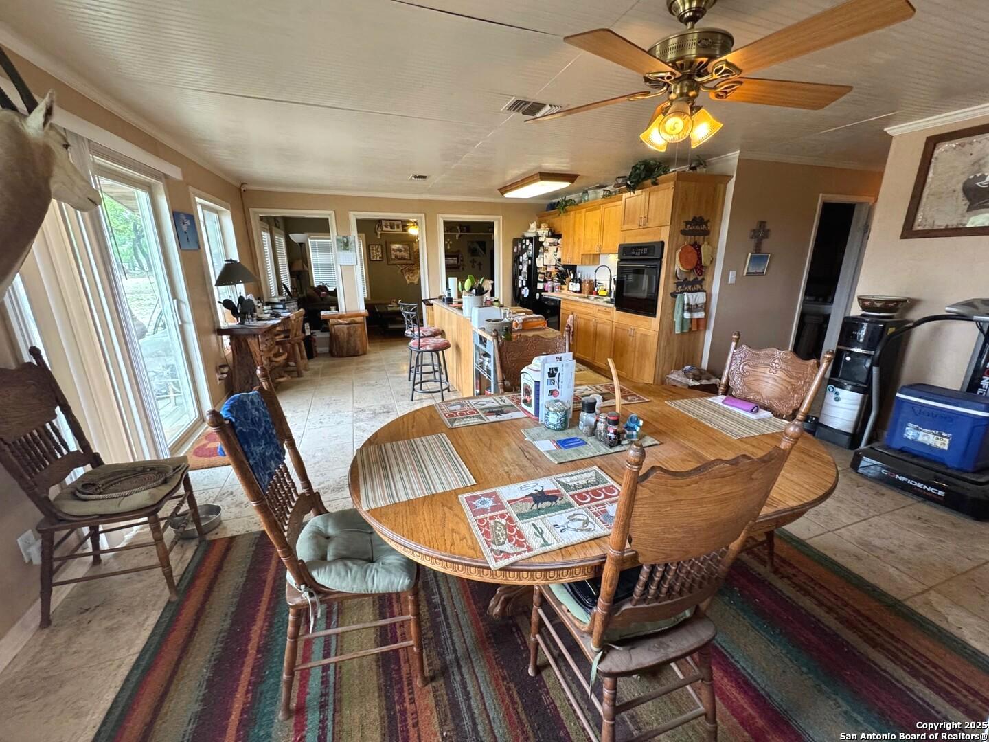 2485 Bump Gate Road Pipe Creek, TX 78063 - Photo 35 of 42 a view of a dining room with furniture window and wooden floor