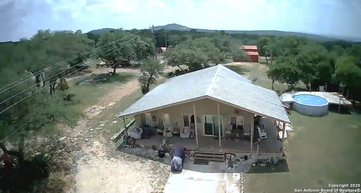 2485 Bump Gate Road Pipe Creek, TX 78063 - Photo 41 of 42 a backyard of a house with yard fire pit and outdoor seating