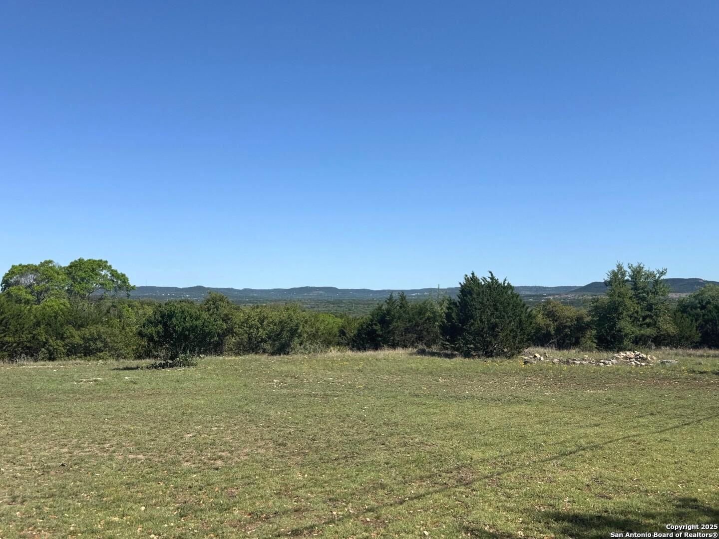 2485 Bump Gate Road Pipe Creek, TX 78063 - Photo 7 of 42 a view of a lake with houses in the back