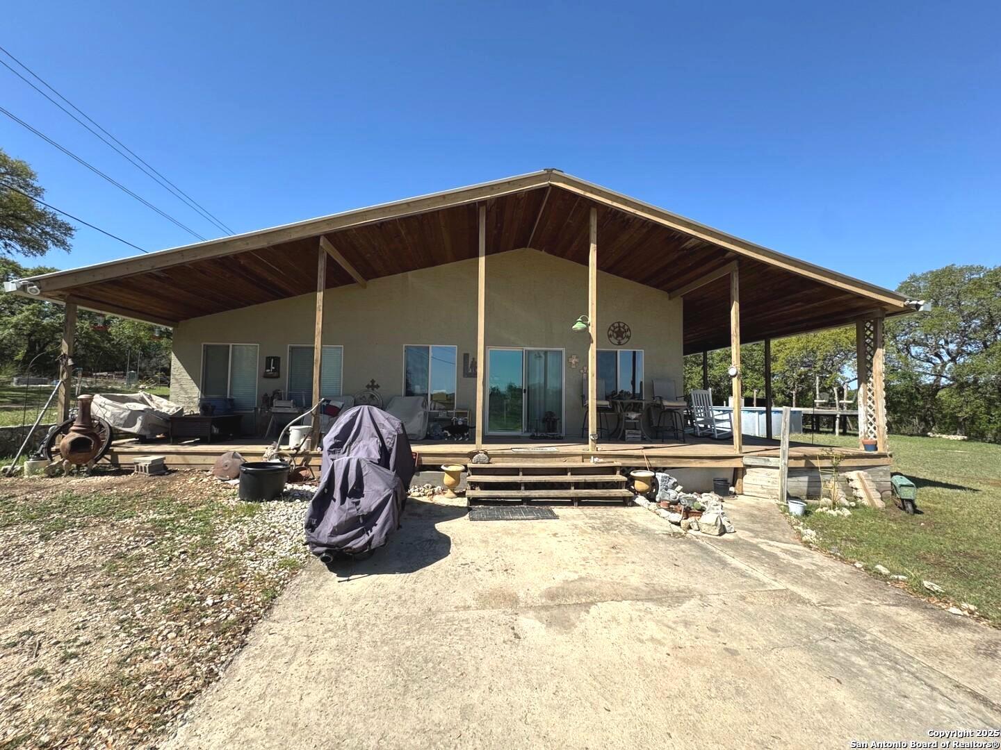 2485 Bump Gate Road Pipe Creek, TX 78063 - Photo 9 of 42 a view of a chair and tables in the patio