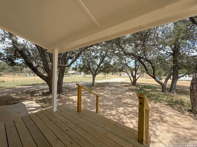 a view of a yard with wooden fence