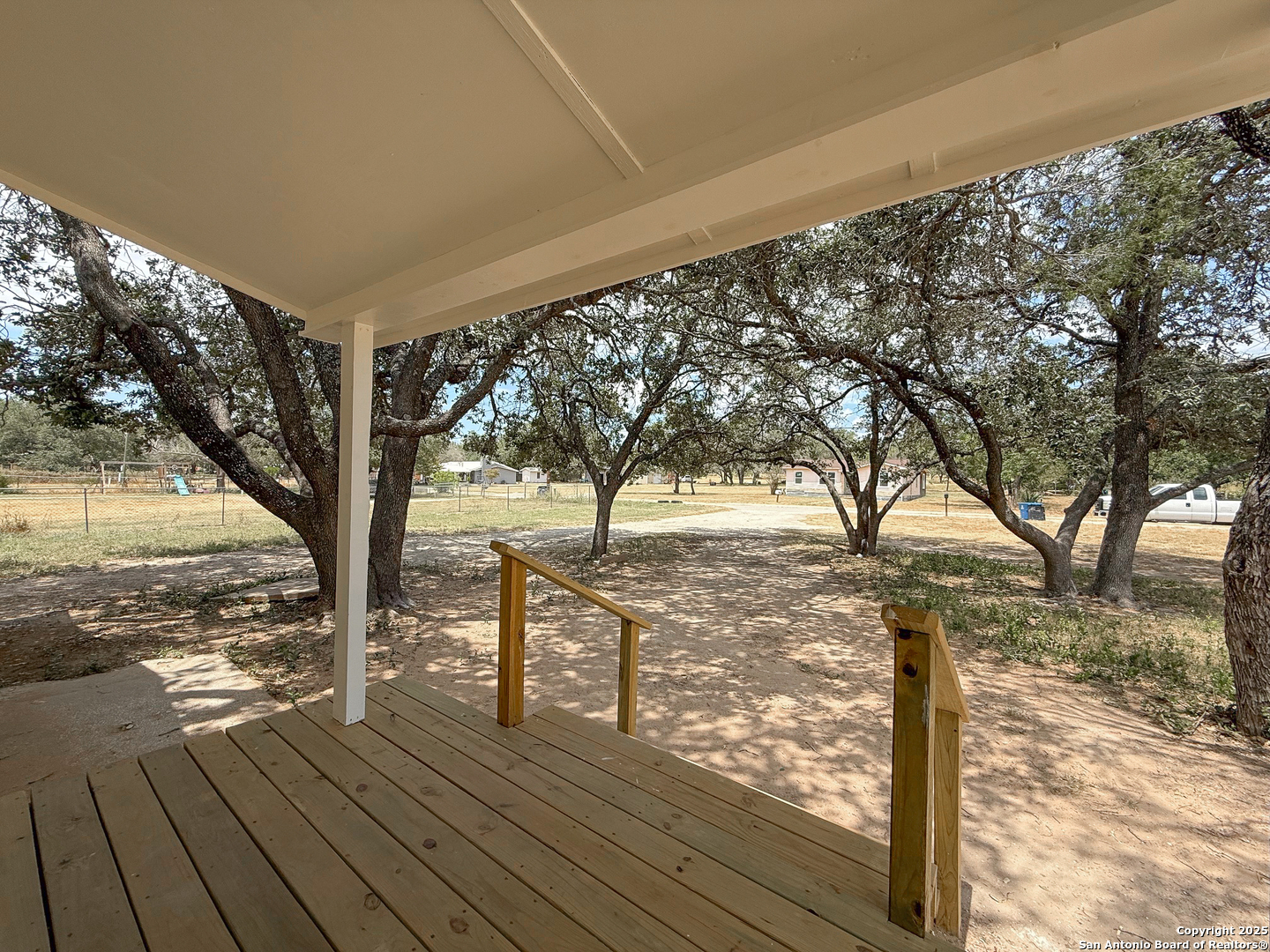 303 Davis Avenue Devine, TX 78016 - Photo 13 of 16 a view of a yard with wooden fence