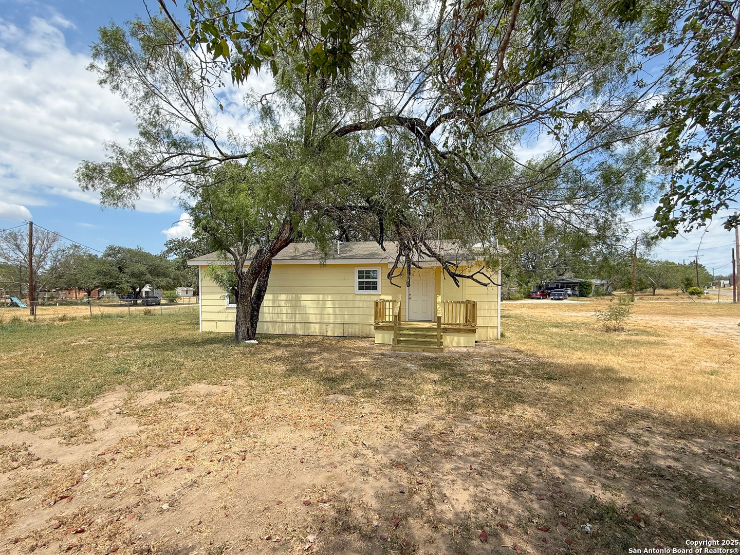 303 Davis Avenue Devine, TX 78016 - Photo 16 of 16 a view of a house with a yard