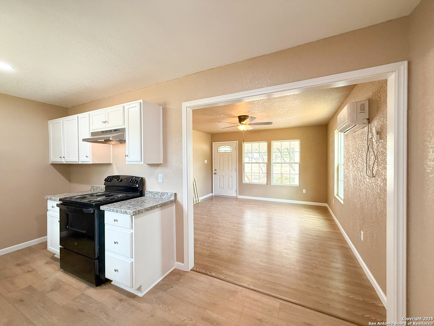 303 Davis Avenue Devine, TX 78016 - Photo 6 of 16 a view of a kitchen with a stove top oven