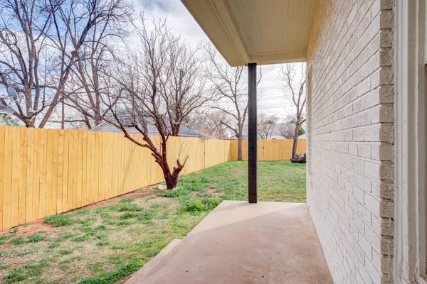 a view of a backyard with large trees