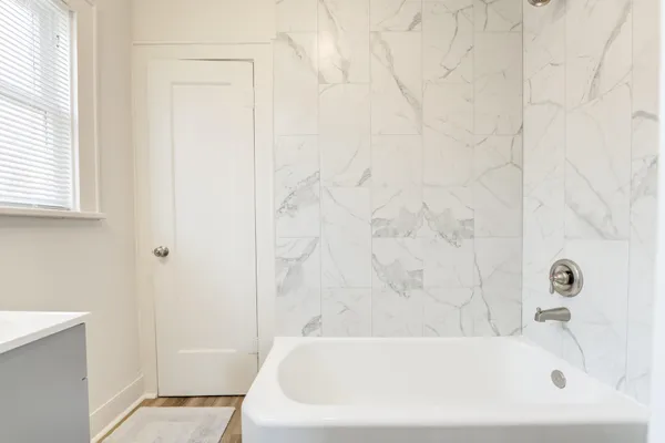 a bathroom with a white bath tub