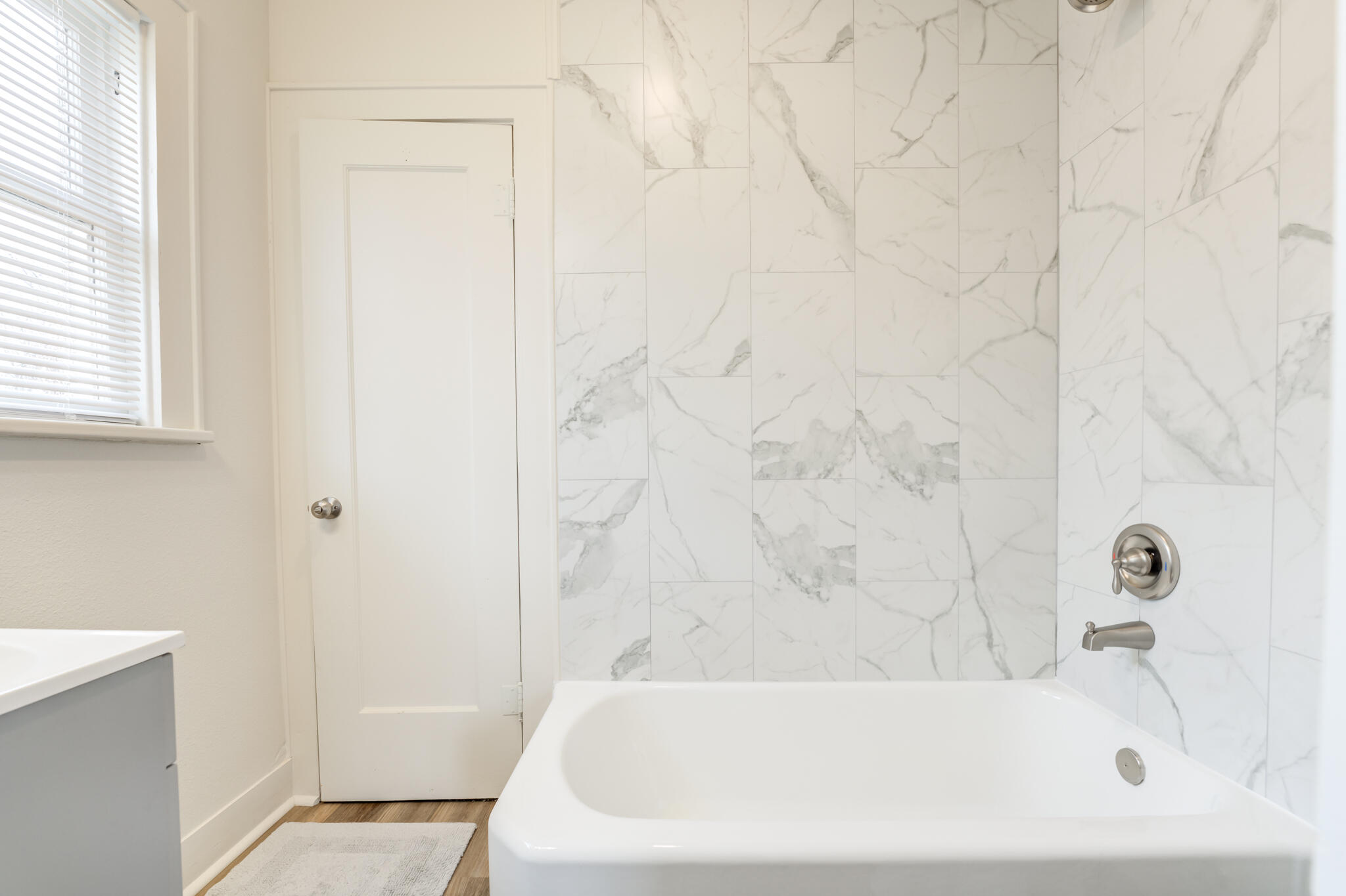 1721 23rd Street Lubbock, TX 79411 - Photo 27 of 29 a bathroom with a white bath tub