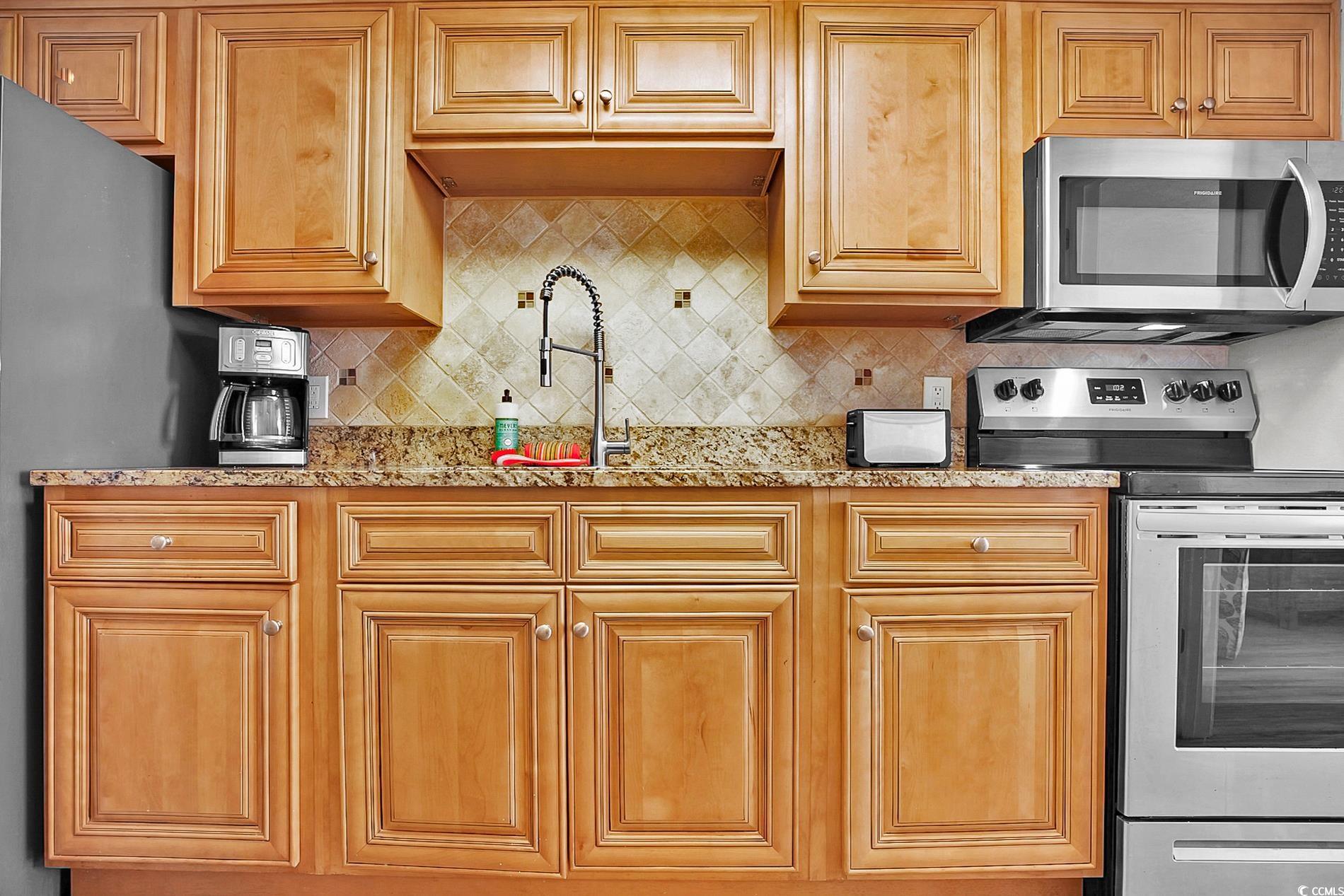7200 North Ocean Boulevard, Unit 553 Myrtle Beach, SC 29572 - Photo 16 of 27 Kitchen view of light stone counters