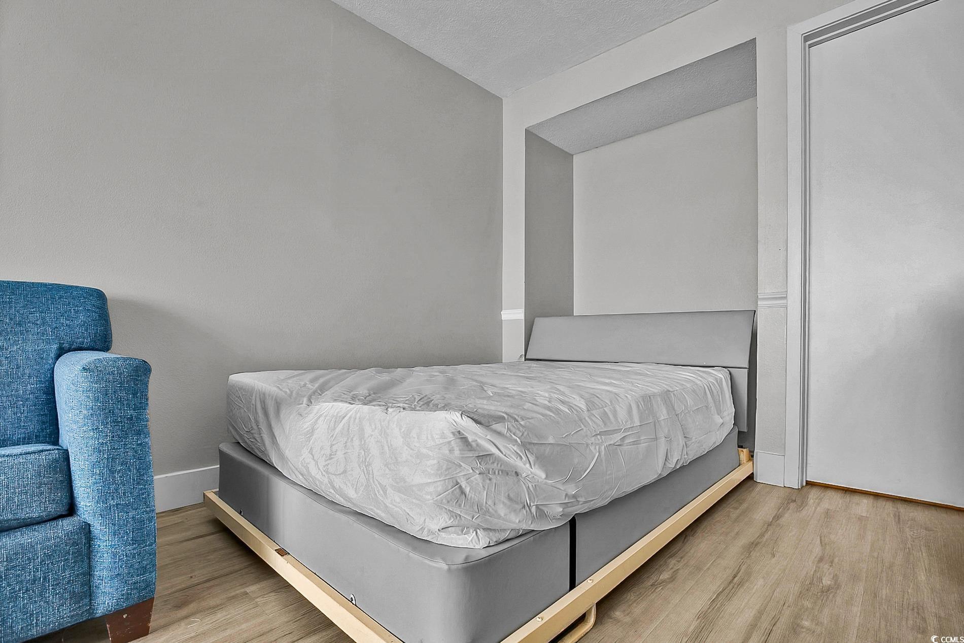 7200 North Ocean Boulevard, Unit 553 Myrtle Beach, SC 29572 - Photo 9 of 27 Living room with light wood-style flooring and a textured ceiling