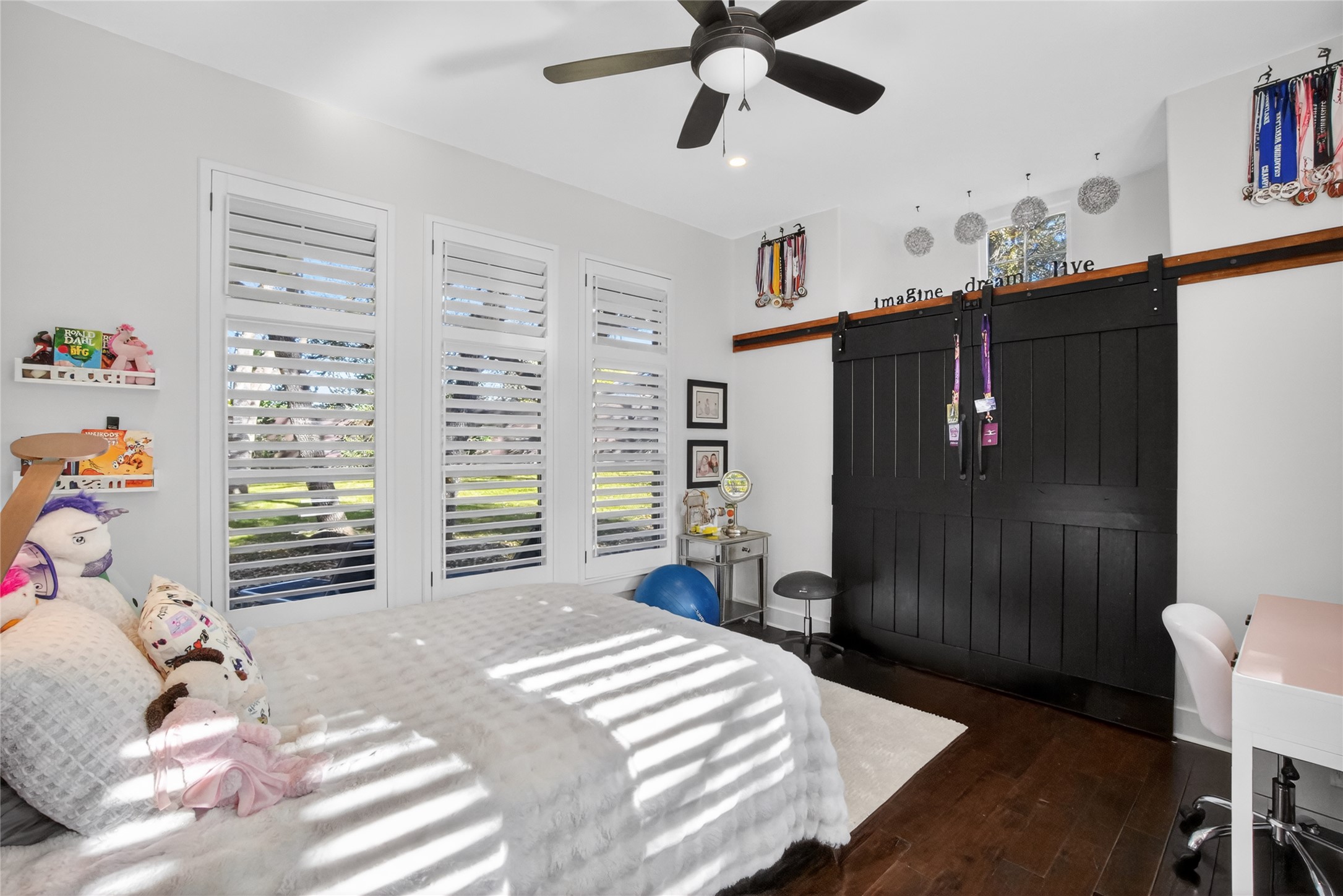 3627 Stoneridge Road Austin, TX 78746 - Photo 14 of 40 Bedroom featuring a barn door, dark wood-style floors, a ceiling fan, and recessed lighting