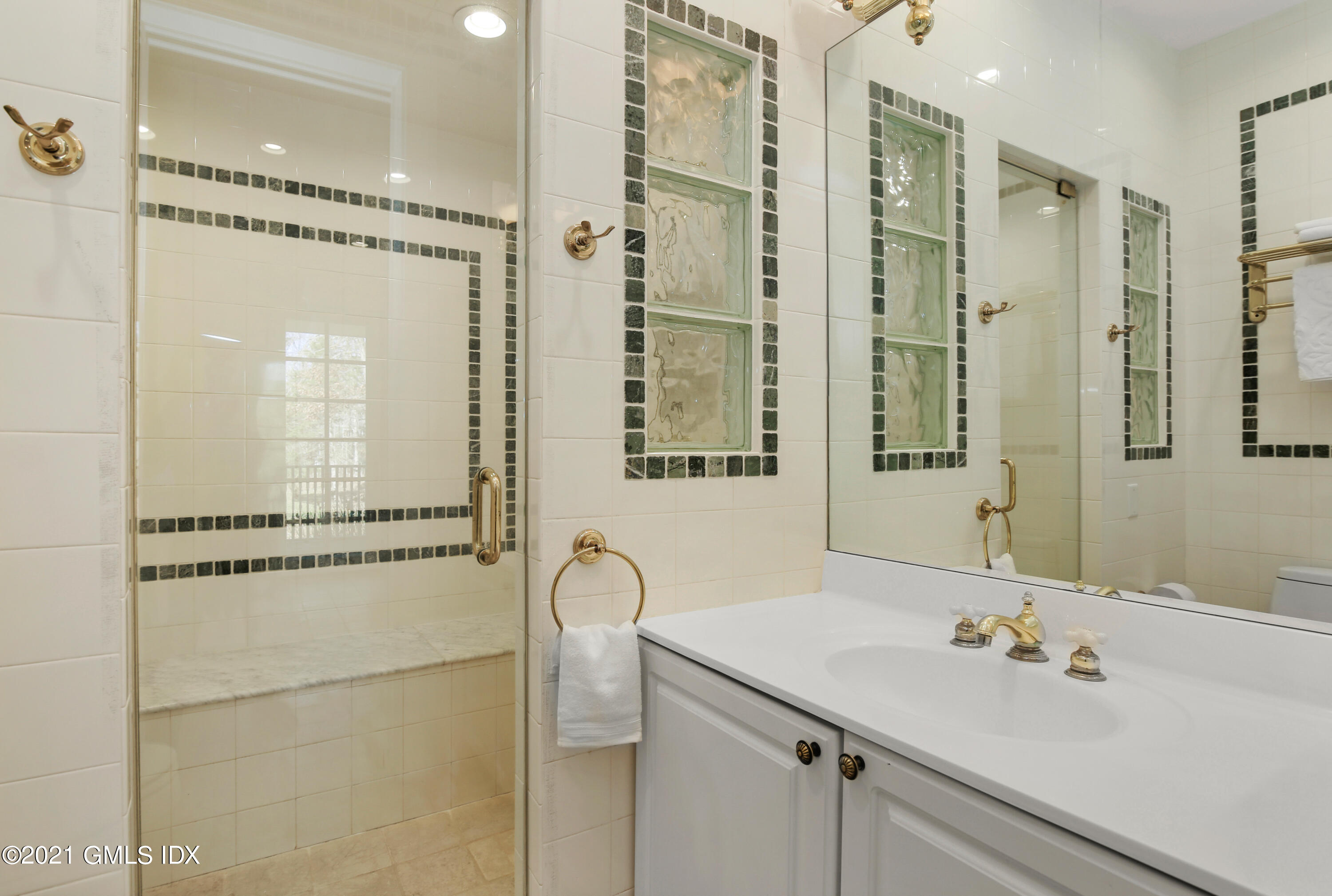 1 Juniper Hill Road Greenwich, CT 06830 - Photo 20 of 73 a bathroom with a shower sink and mirror