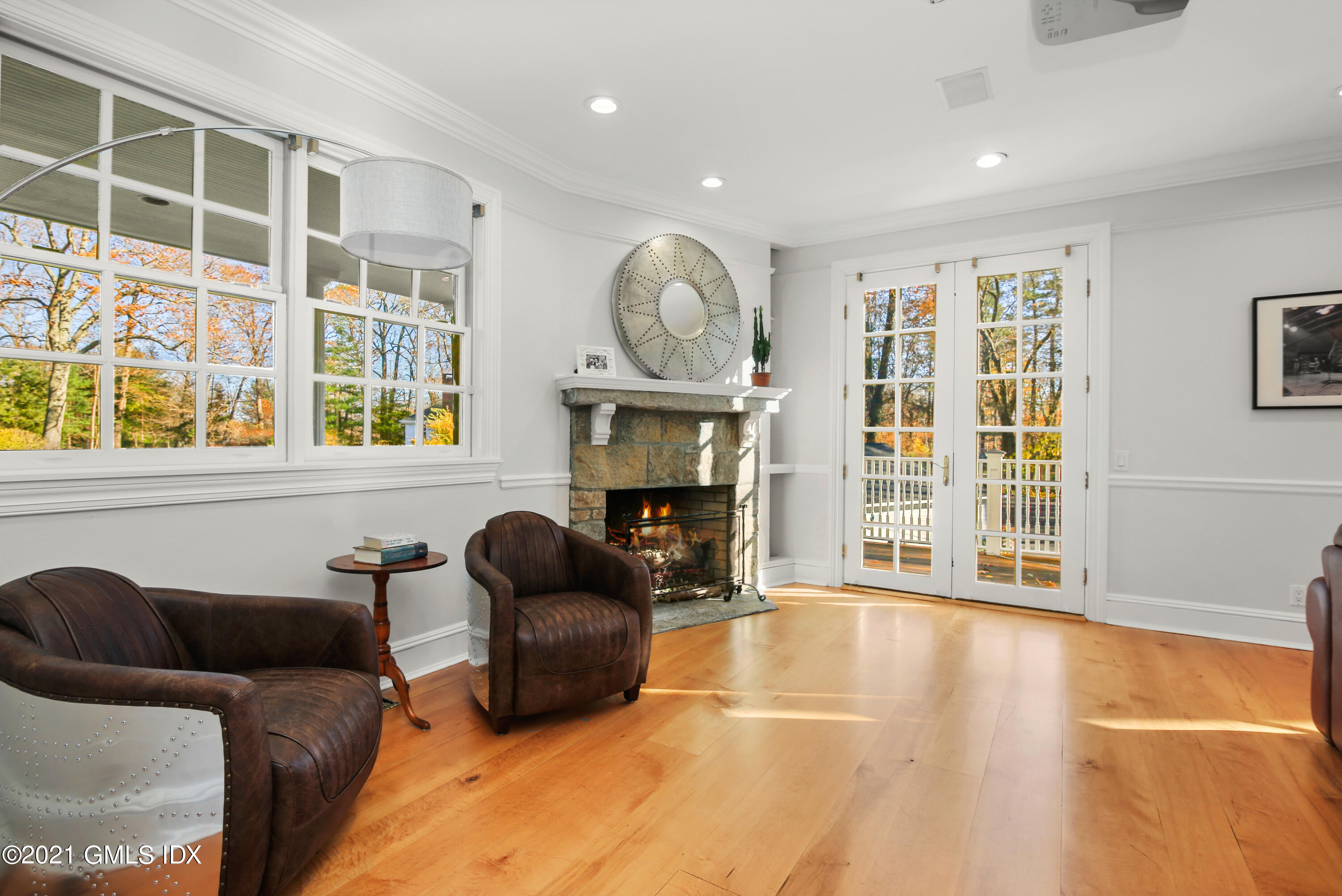 1 Juniper Hill Road Greenwich, CT 06830 - Photo 23 of 73 a living room with furniture a fireplace and a floor to ceiling window