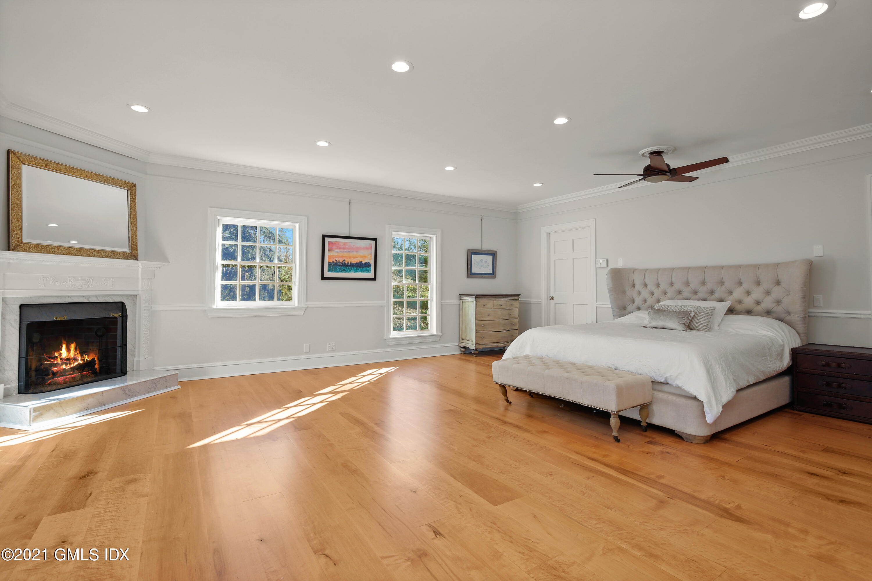 1 Juniper Hill Road Greenwich, CT 06830 - Photo 32 of 73 a spacious bedroom with a large bed and a fireplace