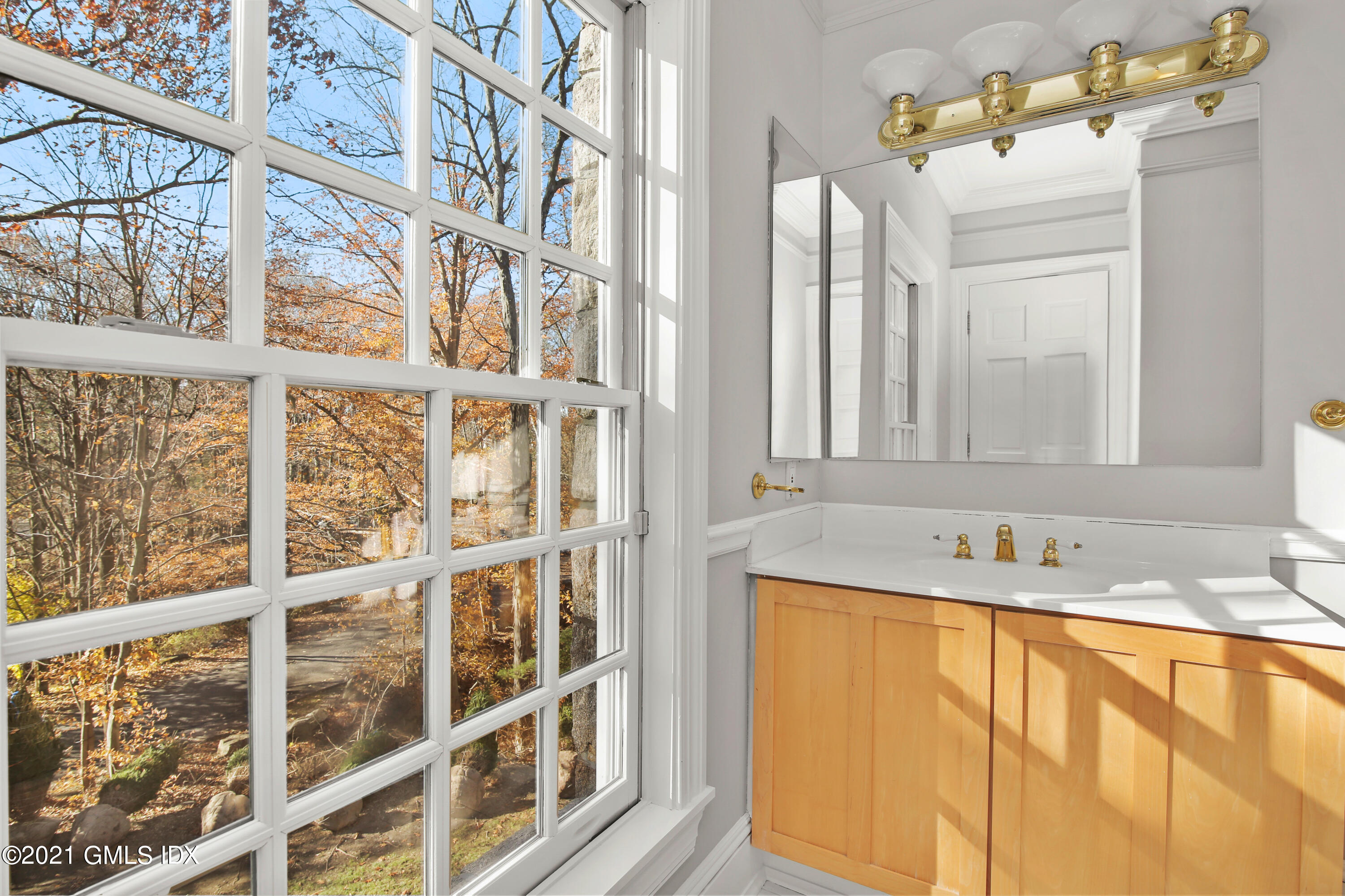 1 Juniper Hill Road Greenwich, CT 06830 - Photo 40 of 73 a bathroom with a sink and a mirror