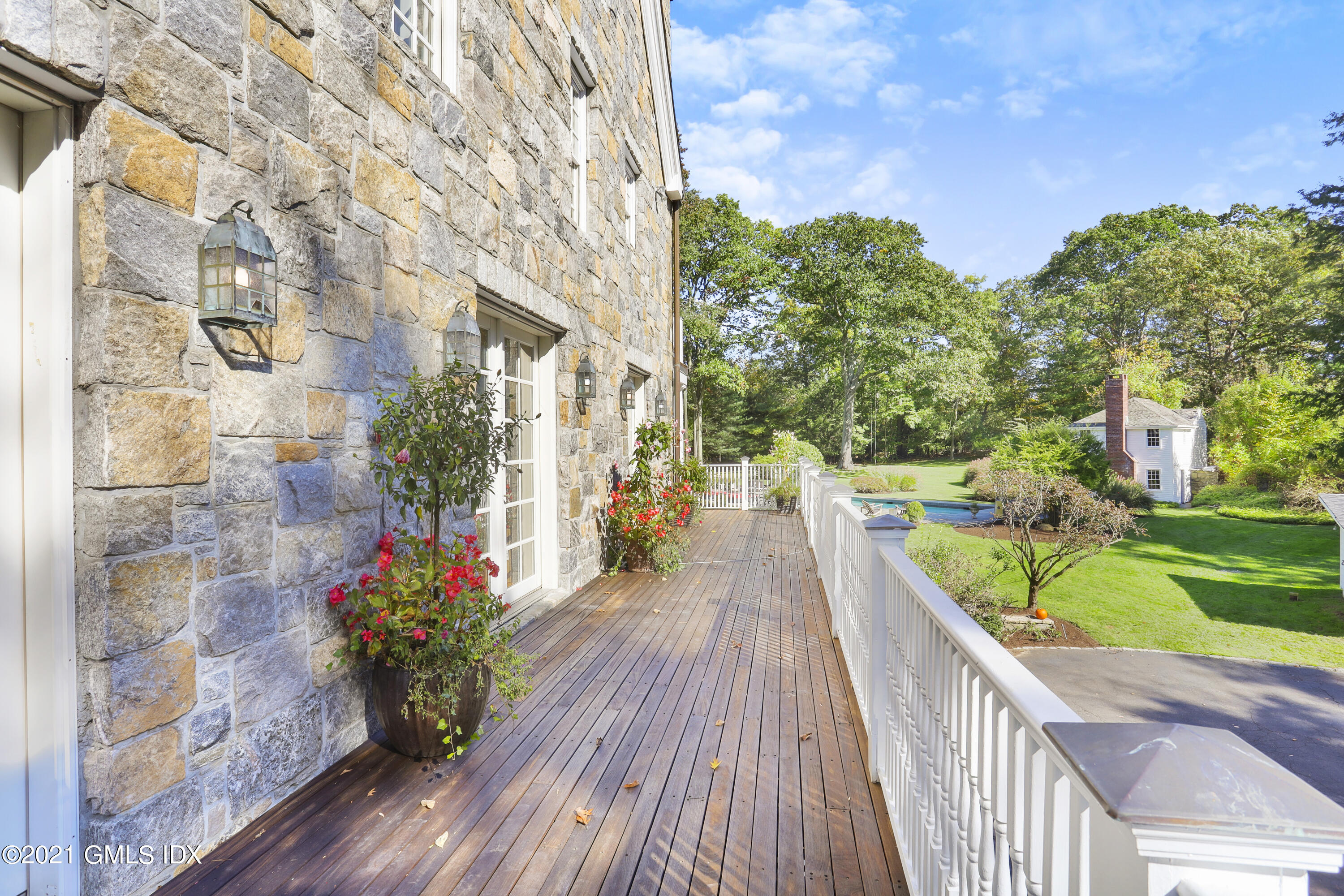 1 Juniper Hill Road Greenwich, CT 06830 - Photo 66 of 73 a view of a house with a backyard and a patio