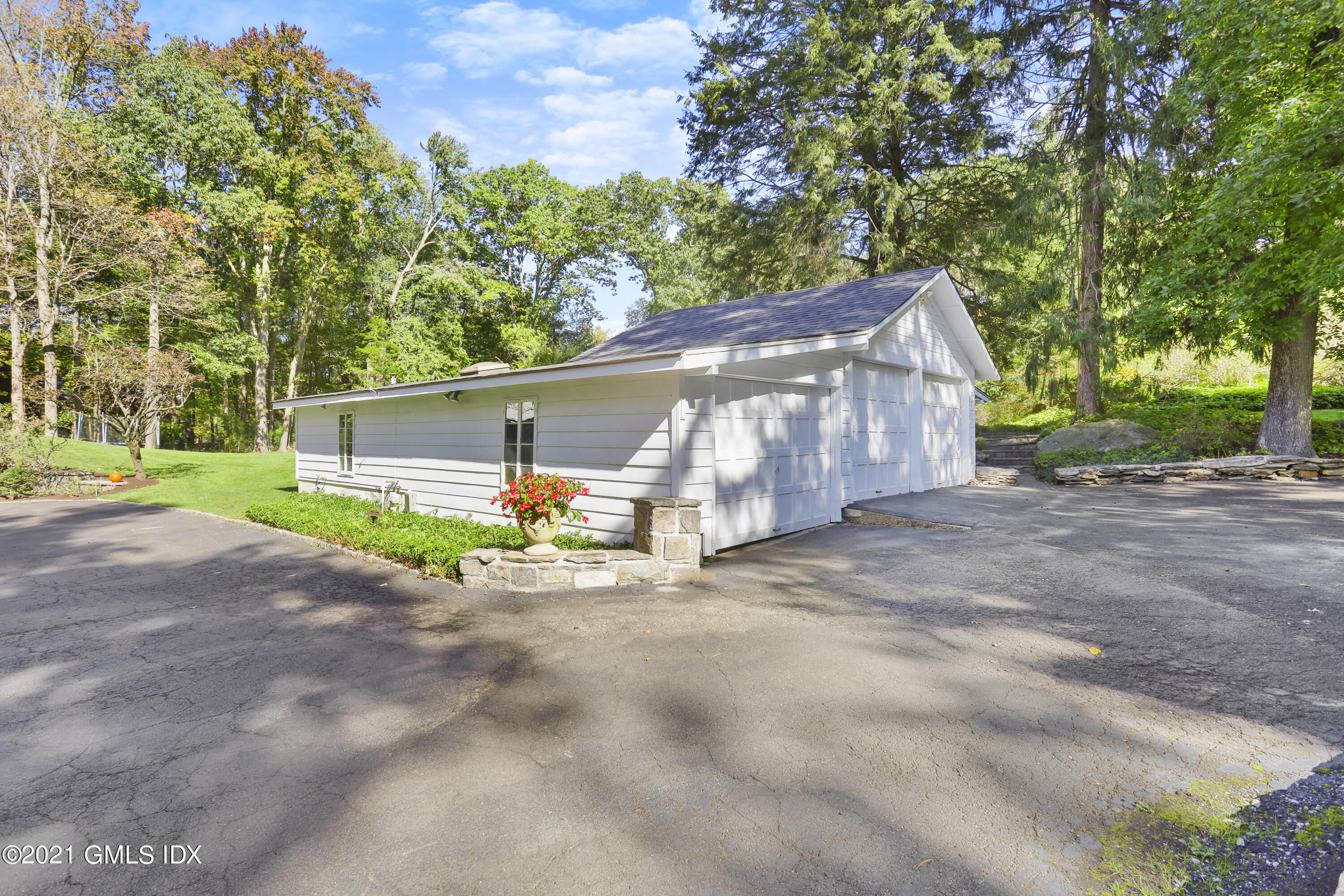 1 Juniper Hill Road Greenwich, CT 06830 - Photo 67 of 73 a view of a house with a big yard and large trees