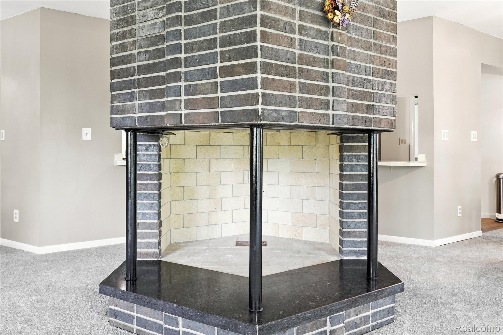 7386 Dean Road Fenton, MI 48430 - Photo 20 of 64 Brick fireplace with a black granite hearth and a light brick firebox