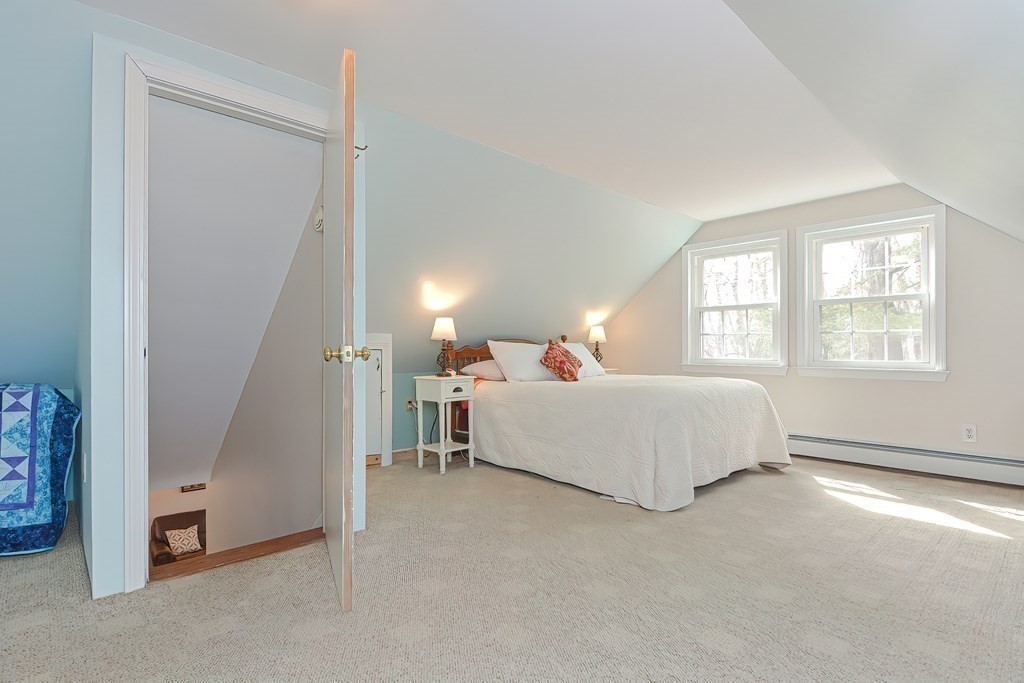 38 Red Acre Road Stow, MA 01775 - Photo 31 of 41 a spacious bedroom with a bed and a window