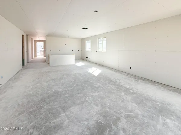 a view of empty room with window and refrigerator