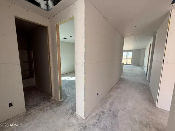 a view of a hallway to an empty room