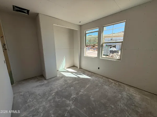 an empty room with windows and closet