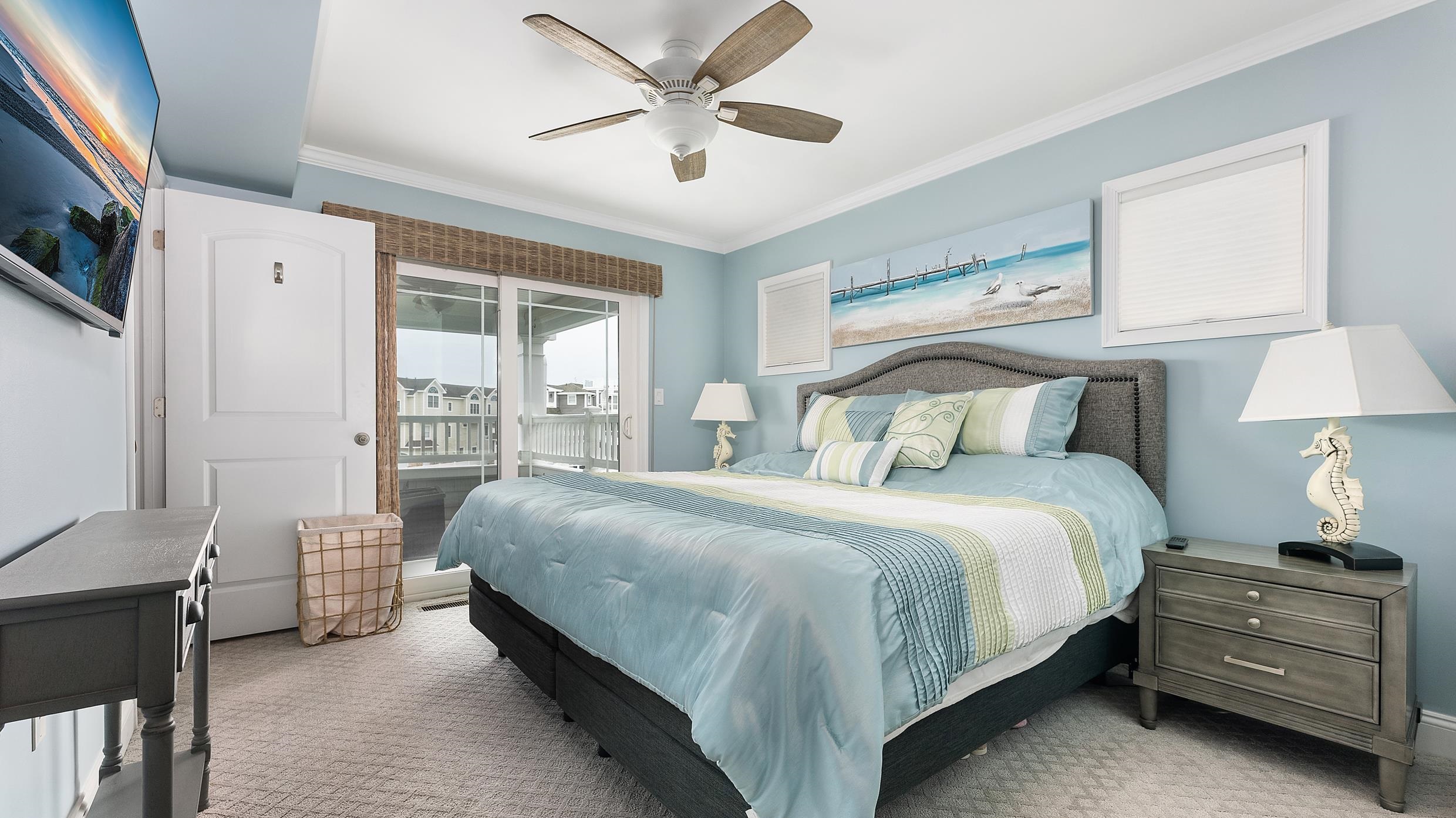 4477 Venicean Road, Unit SOUTH Sea Isle City, NJ 08243 - Photo 13 of 36 a bedroom with a bed and a chandelier