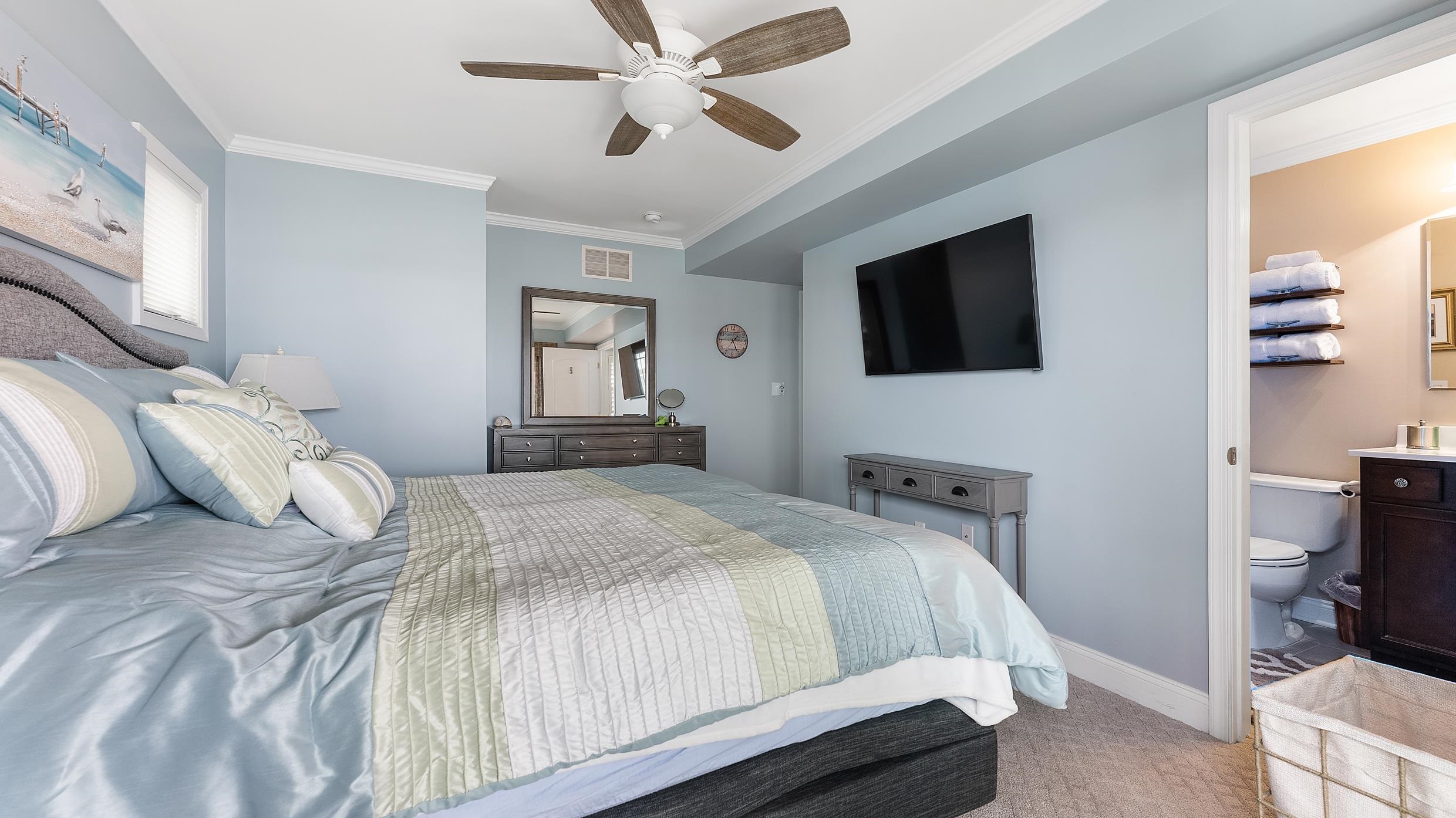 4477 Venicean Road, Unit SOUTH Sea Isle City, NJ 08243 - Photo 14 of 36 a bedroom with a bed and a flat screen tv