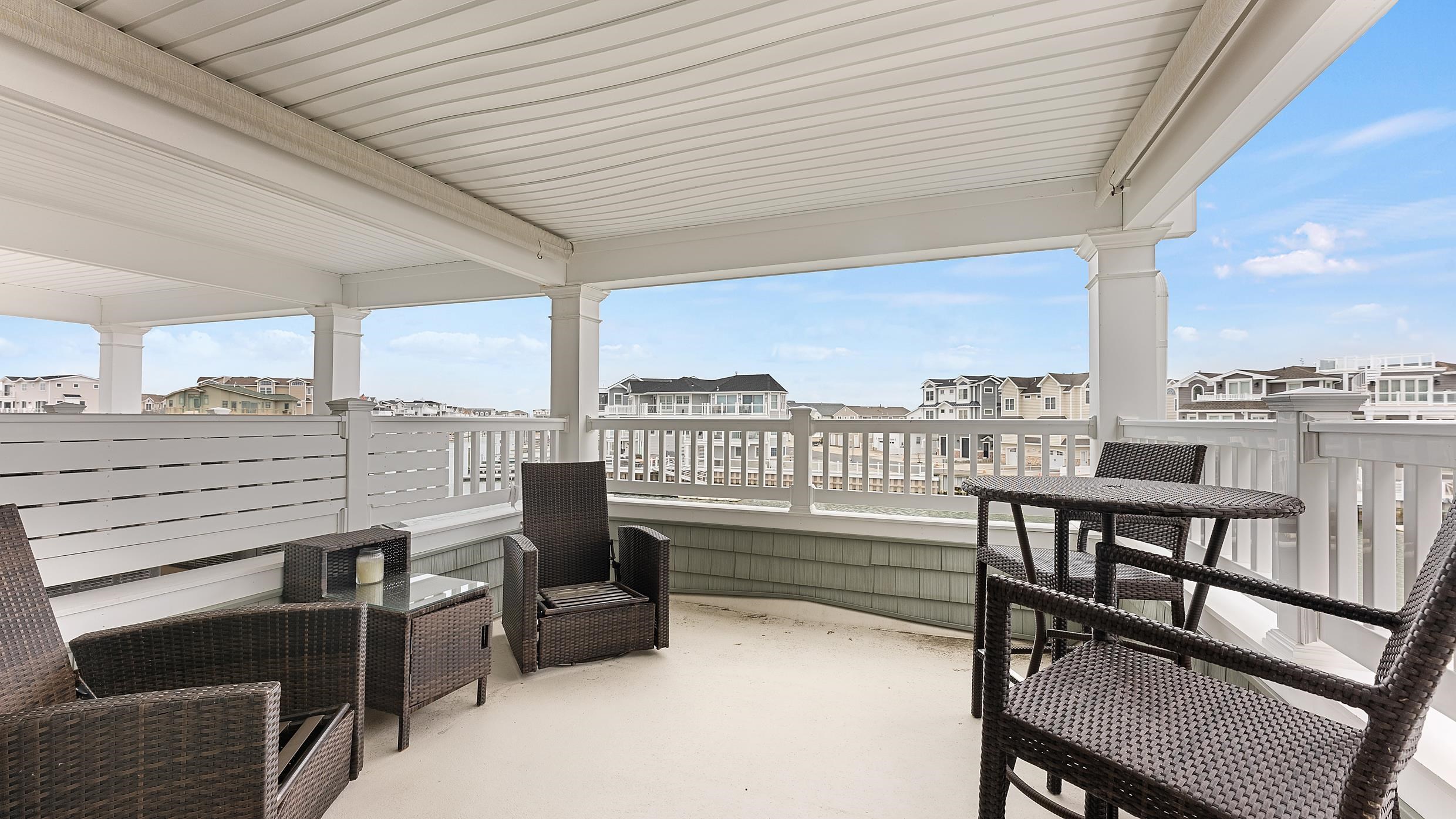 4477 Venicean Road, Unit SOUTH Sea Isle City, NJ 08243 - Photo 16 of 36 a view of a balcony with furniture