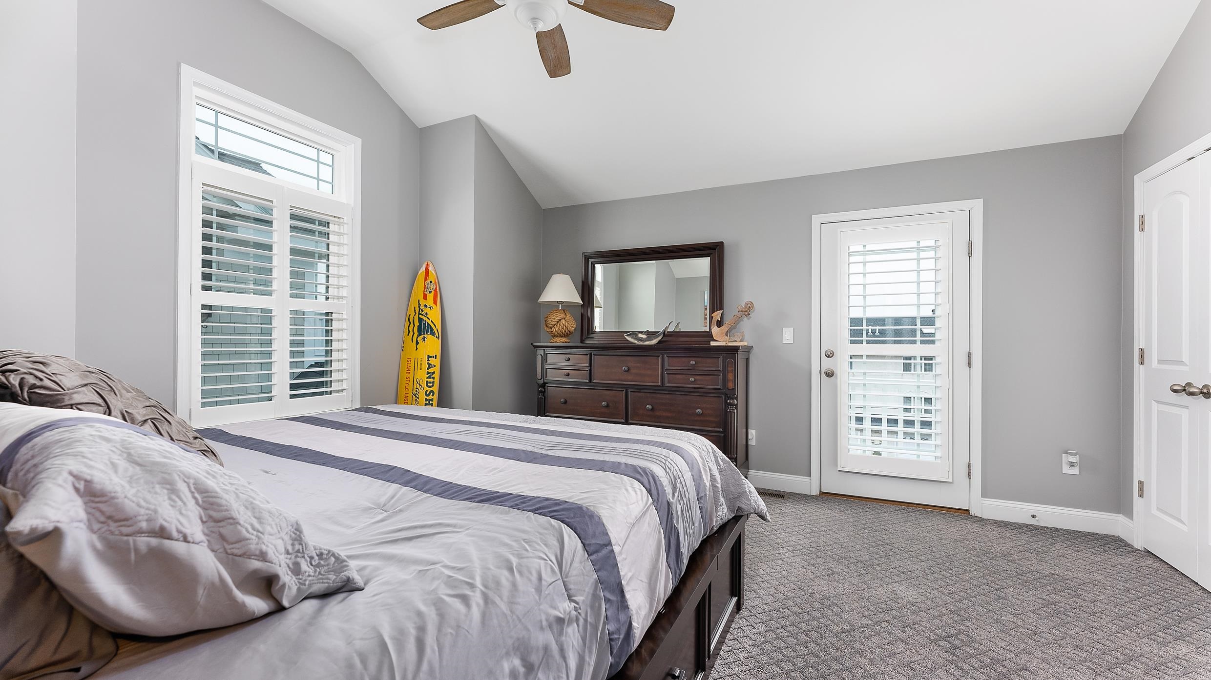 4477 Venicean Road, Unit SOUTH Sea Isle City, NJ 08243 - Photo 21 of 36 a bedroom with a bed next to a window with a dresser