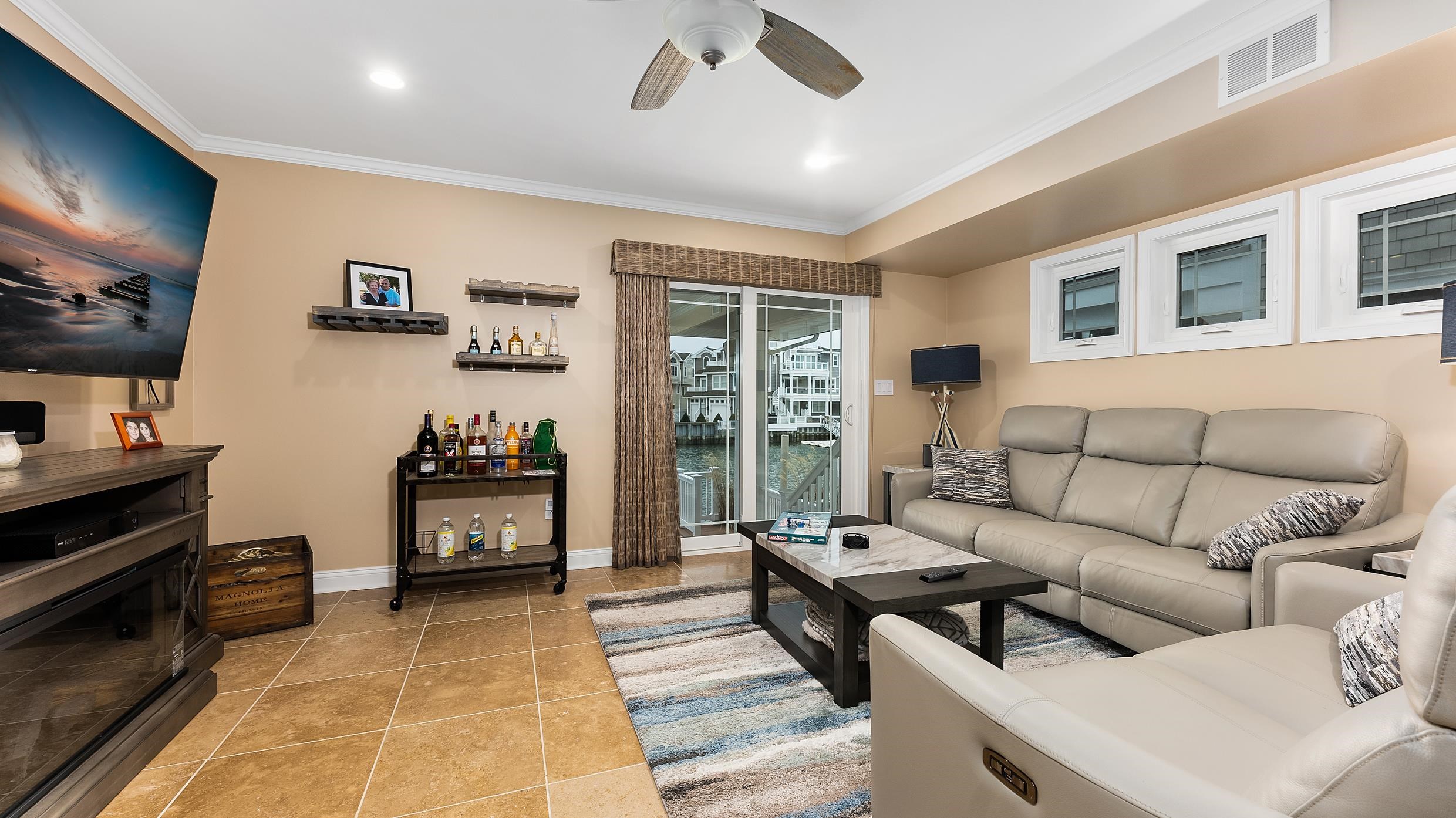 4477 Venicean Road, Unit SOUTH Sea Isle City, NJ 08243 - Photo 29 of 36 a living room with furniture and a flat screen tv