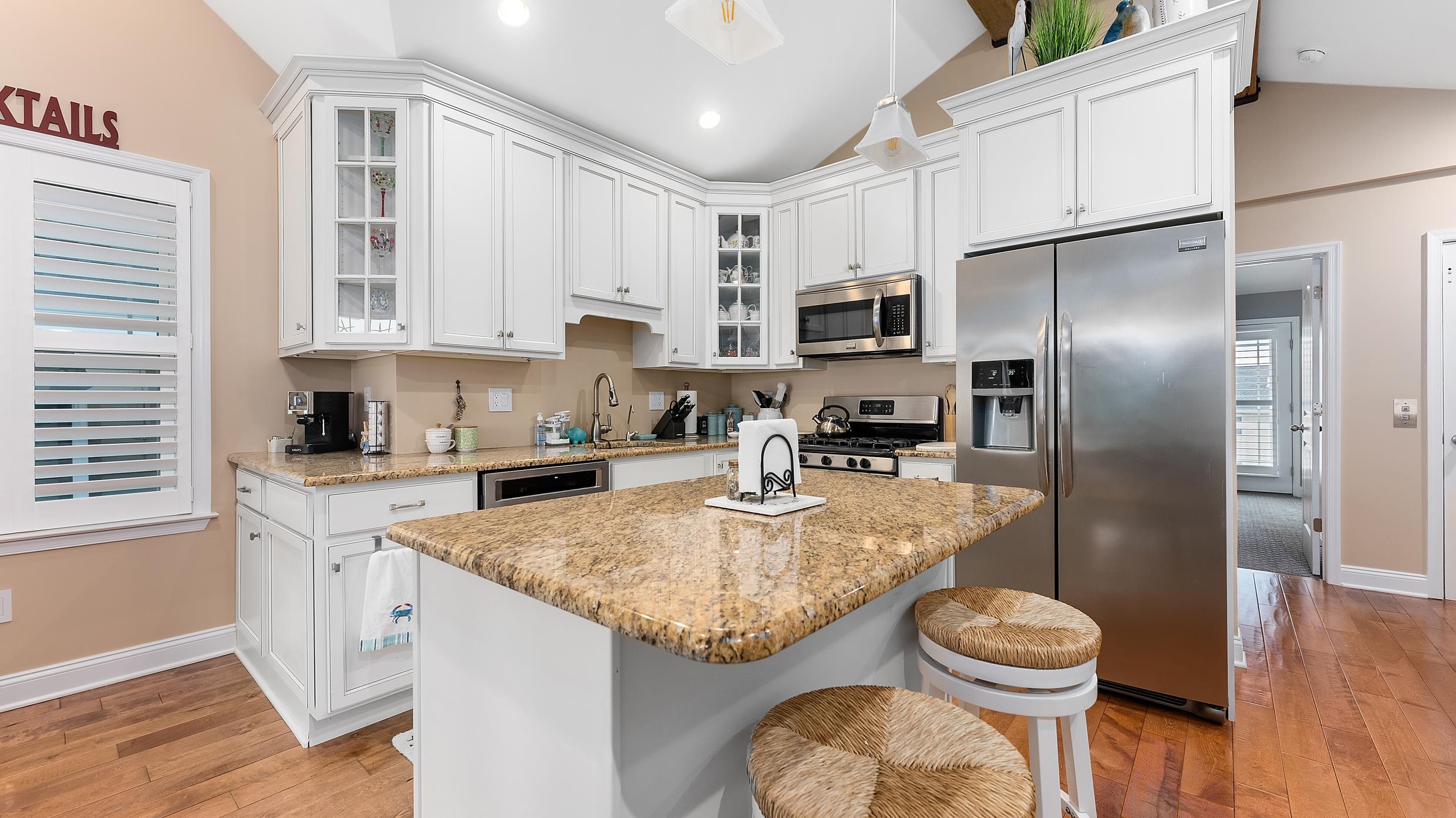 4477 Venicean Road, Unit SOUTH Sea Isle City, NJ 08243 - Photo 3 of 36 a kitchen with kitchen island granite countertop a sink a center island stainless steel appliances cabinets and a counter top space