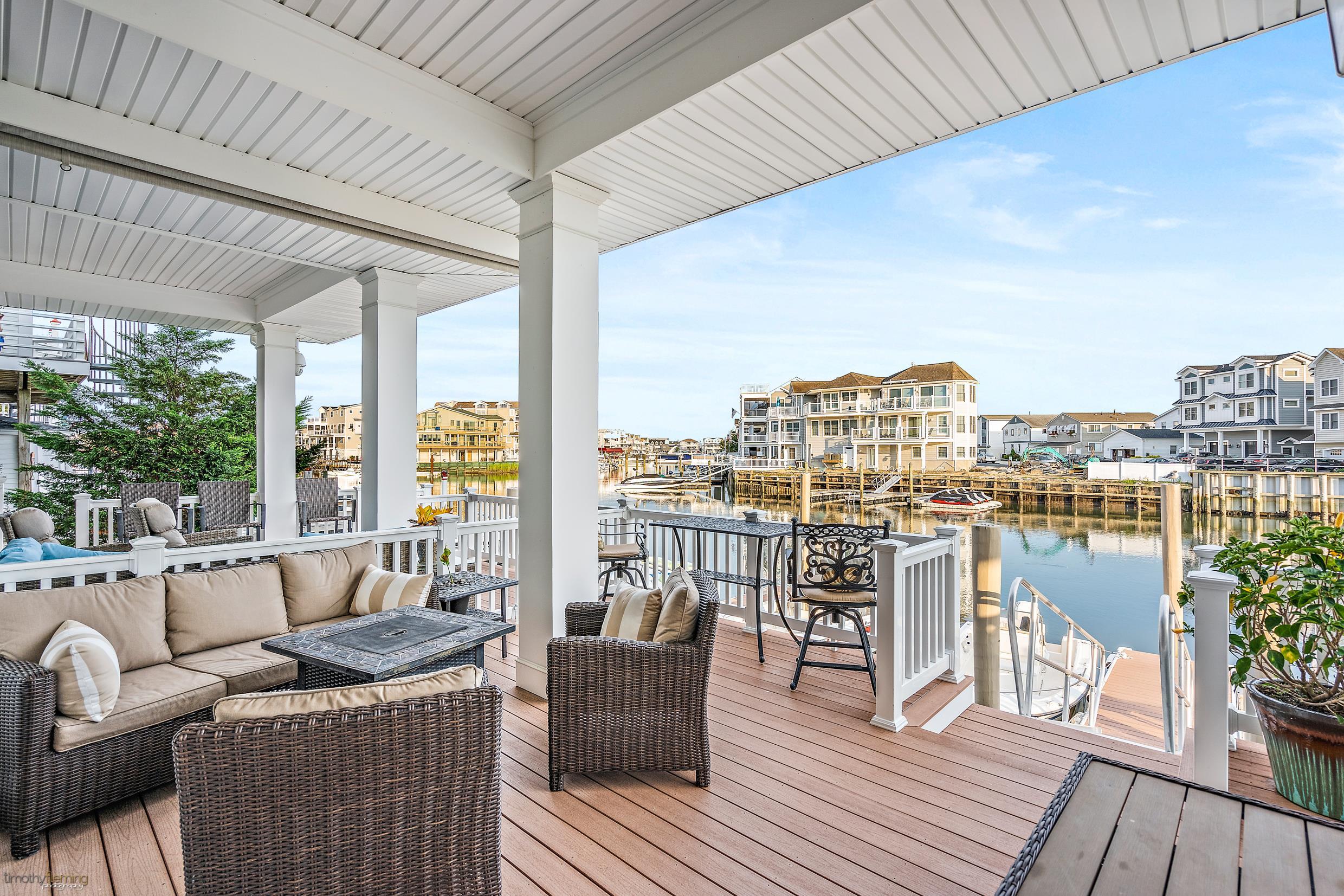 4477 Venicean Road, Unit SOUTH Sea Isle City, NJ 08243 - Photo 33 of 36 a balcony with furniture and a floor to ceiling window