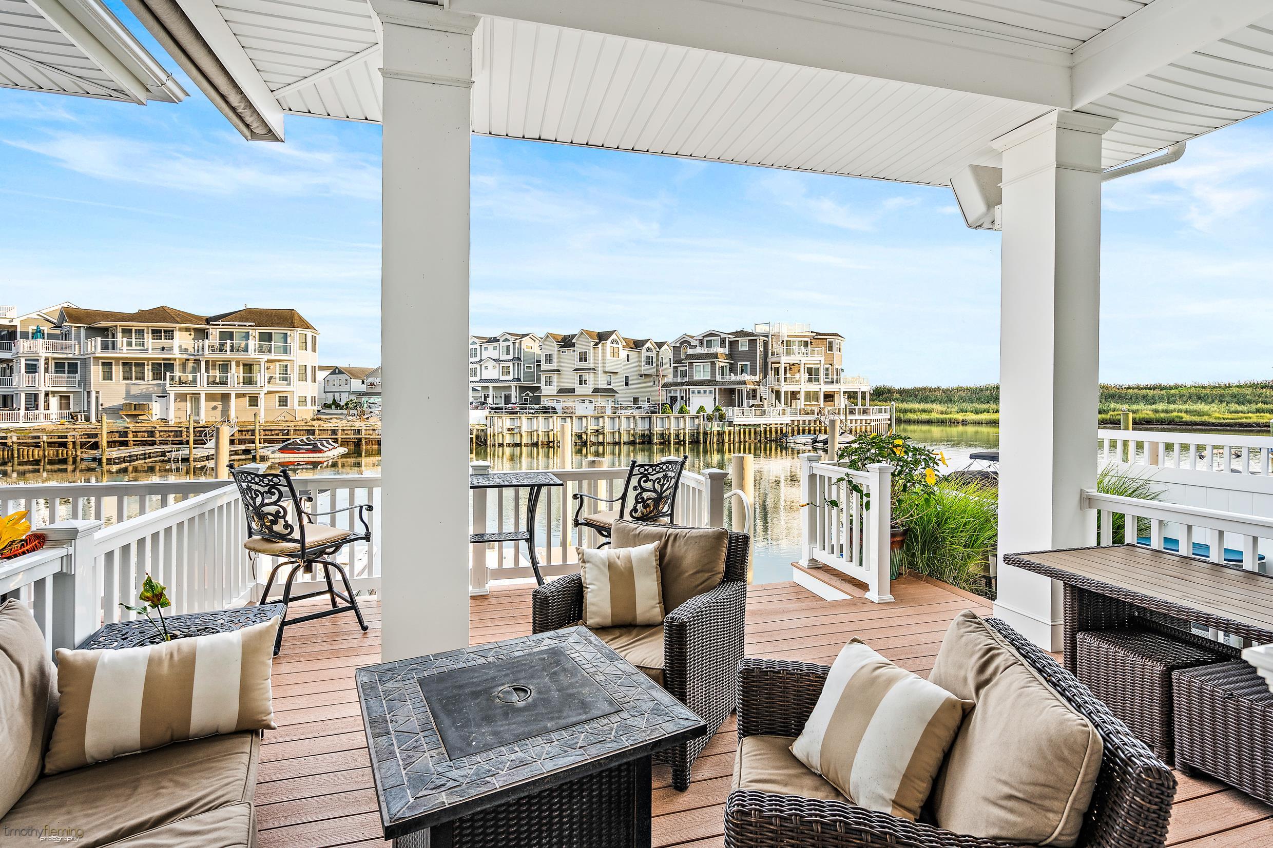 4477 Venicean Road, Unit SOUTH Sea Isle City, NJ 08243 - Photo 35 of 36 a living room with furniture and a floor to ceiling window
