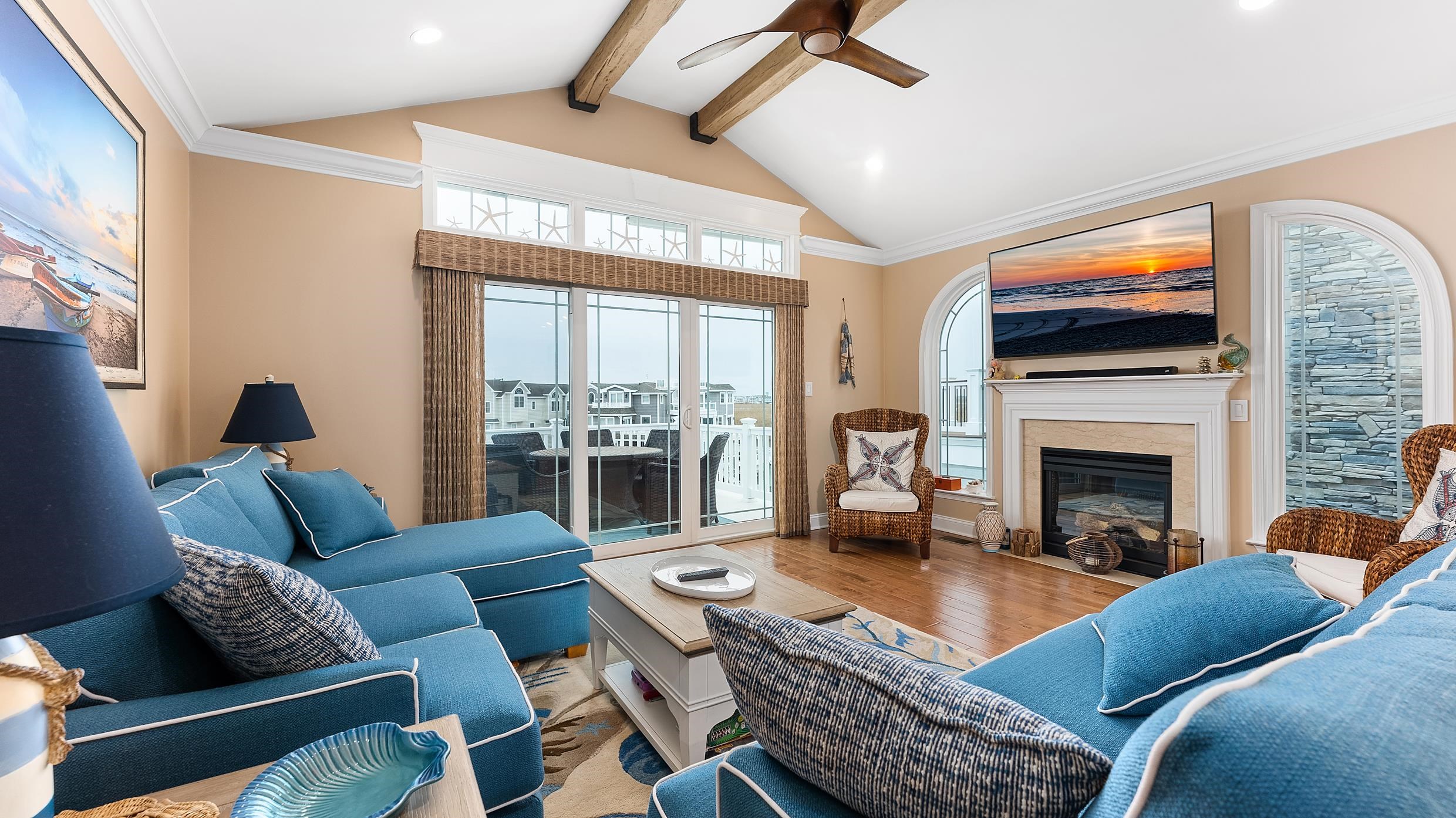 4477 Venicean Road, Unit SOUTH Sea Isle City, NJ 08243 - Photo 8 of 36 a living room with furniture a flat screen tv and a fireplace