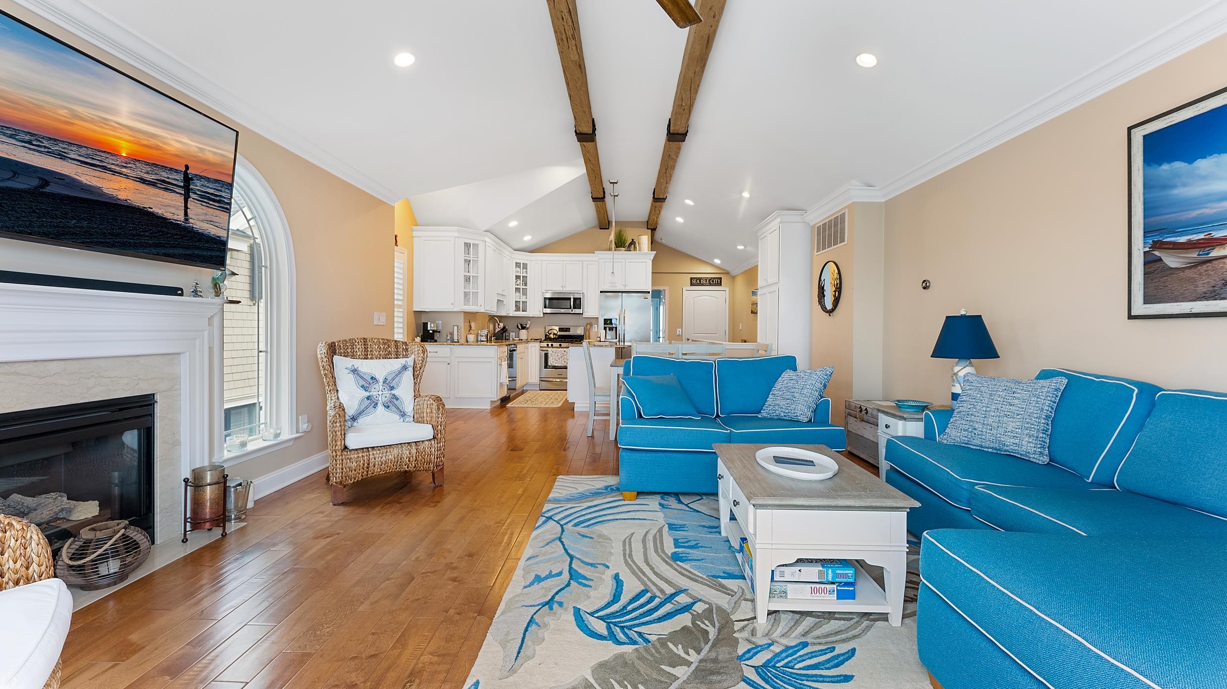 4477 Venicean Road, Unit SOUTH Sea Isle City, NJ 08243 - Photo 9 of 36 a living room with furniture fireplace and a flat screen tv