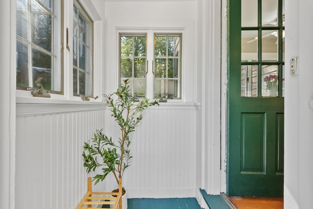 25 Naples Road Melrose, MA 02176 - Photo 4 of 36 a white vase with flowers on a window sill and a window