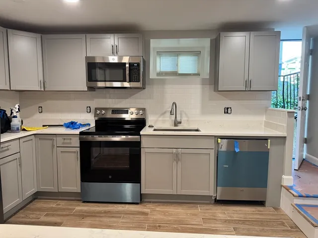 a kitchen with a sink stove and microwave