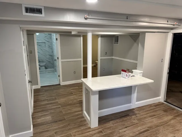 a view of kitchen with sink and wooden floor