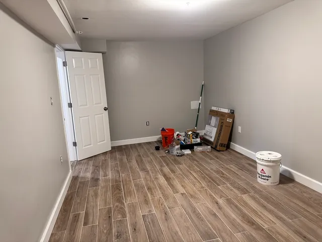 a view of a room with wooden floor and furniture