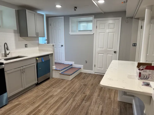 a kitchen with a sink and cabinets
