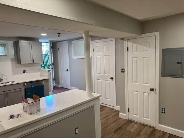 a en suite bathroom with a granite countertop sink and a mirror