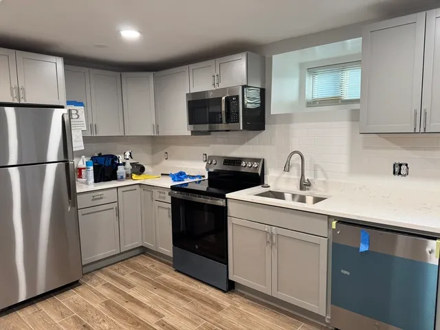 a kitchen with a sink stove and refrigerator