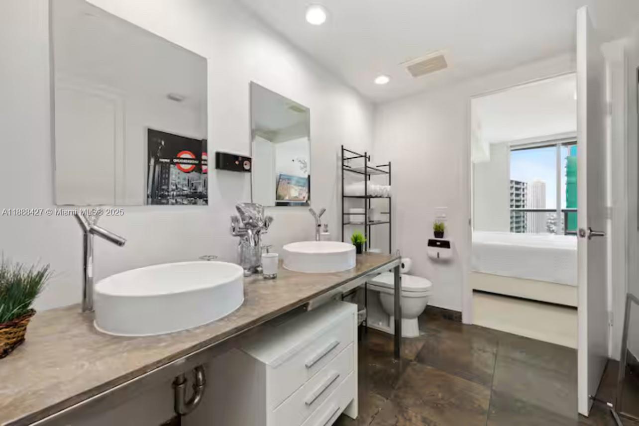 485 Brickell Avenue, Unit 3707 Miami, FL 33131 - Photo 11 of 41 a bathroom with a sink and a mirror