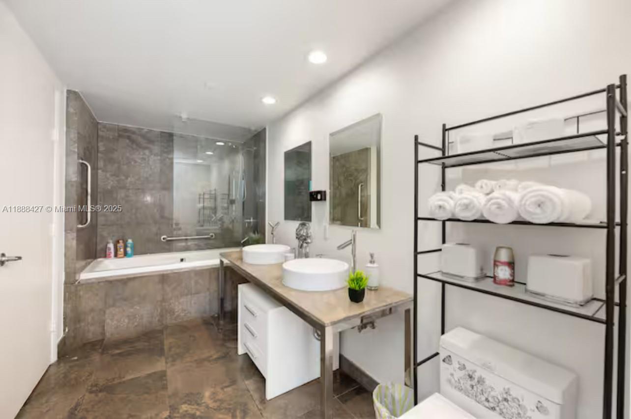 485 Brickell Avenue, Unit 3707 Miami, FL 33131 - Photo 12 of 41 a bathroom with granite countertop lots of white furniture and shower