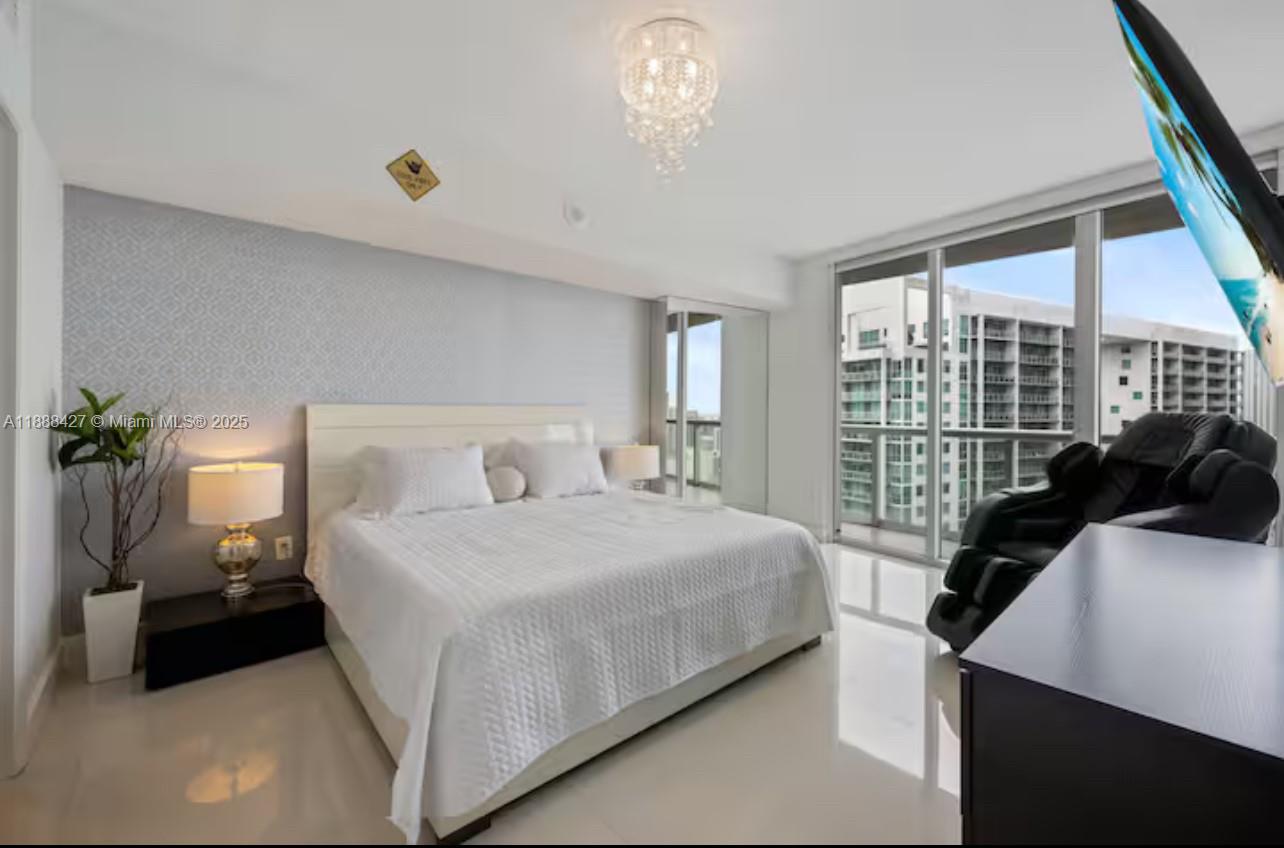 485 Brickell Avenue, Unit 3707 Miami, FL 33131 - Photo 15 of 41 a bedroom with a bed and a large window
