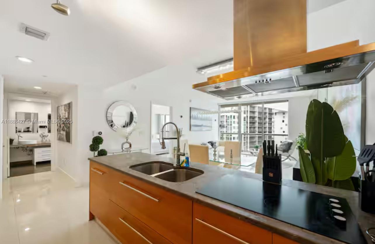 485 Brickell Avenue, Unit 3707 Miami, FL 33131 - Photo 18 of 41 a kitchen with stainless steel appliances granite countertop a sink a counter space and a view of living room