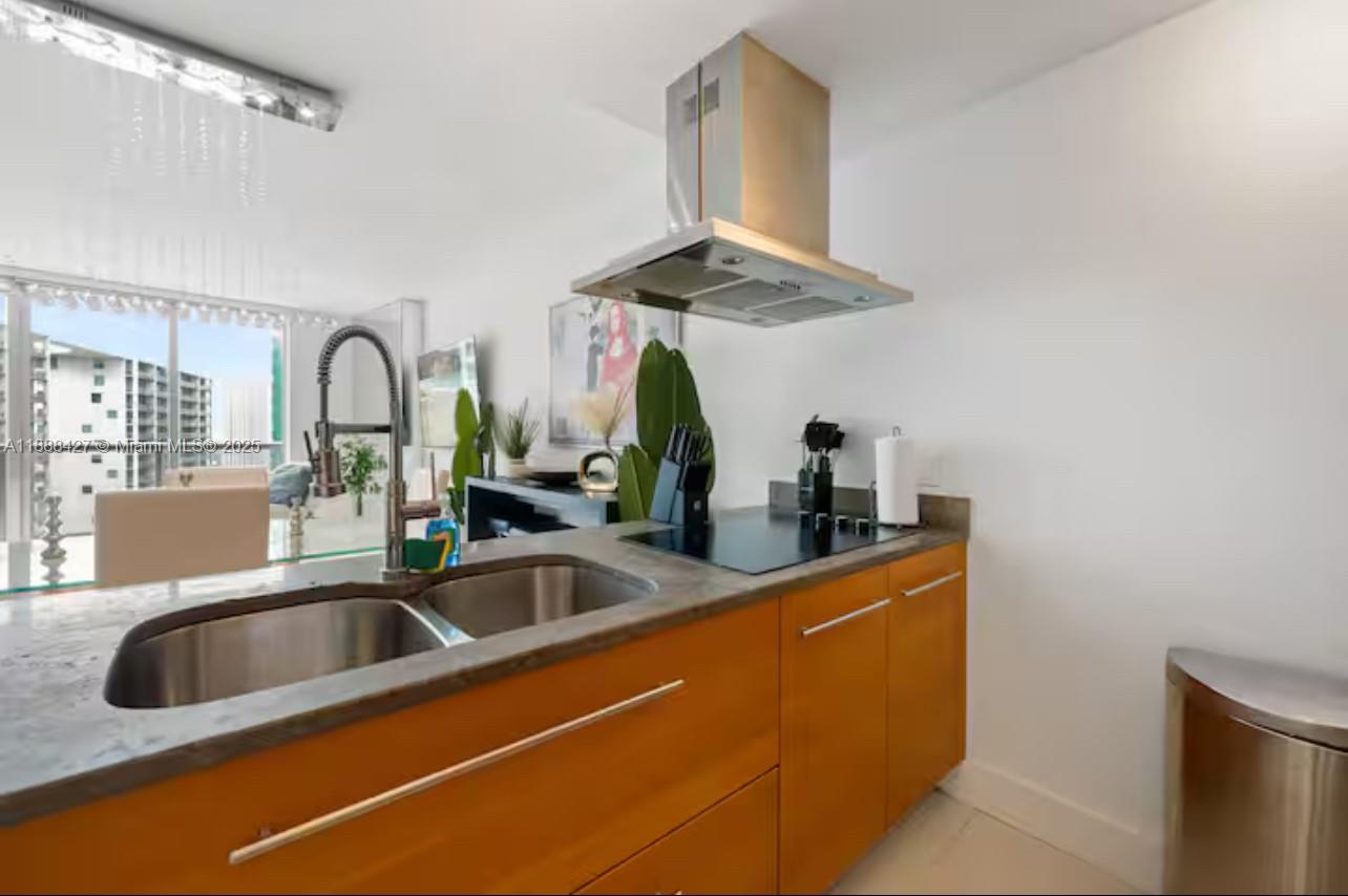 485 Brickell Avenue, Unit 3707 Miami, FL 33131 - Photo 19 of 41 a kitchen with a sink and a wooden floor