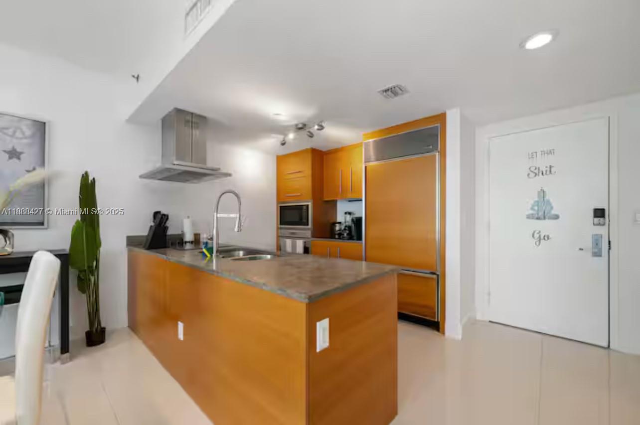 485 Brickell Avenue, Unit 3707 Miami, FL 33131 - Photo 22 of 41 a kitchen with stainless steel appliances granite countertop a refrigerator a stove and a sink