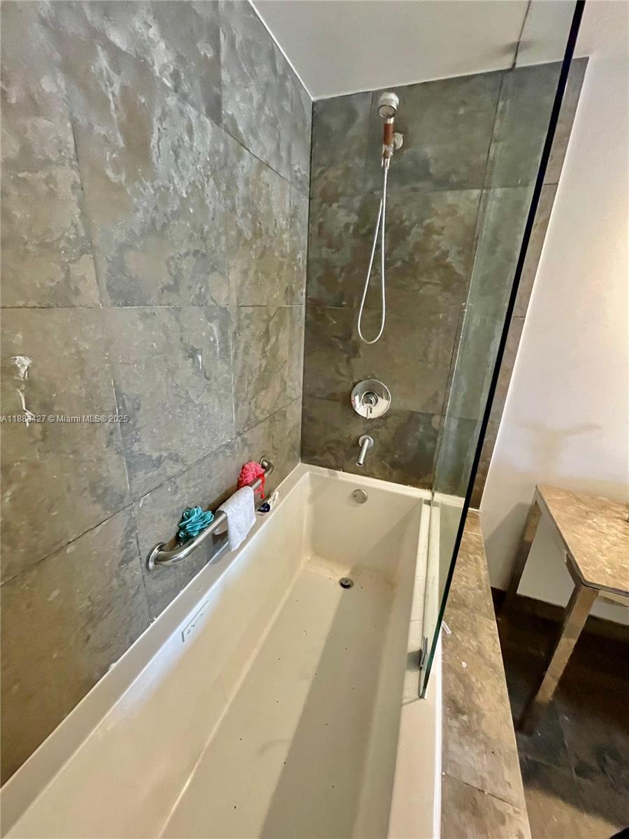 485 Brickell Avenue, Unit 3707 Miami, FL 33131 - Photo 34 of 41 a bathroom with a granite countertop shower and a sink